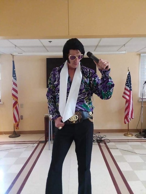 Alan Graveen performing as Elvis in 2-piece outfit with white scarf