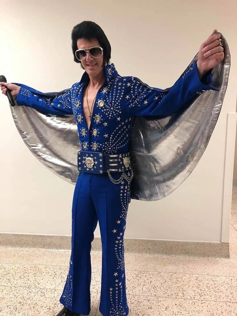 Alan Graveen performing as Elvis in blue jeweled jumpsuit with silver cape